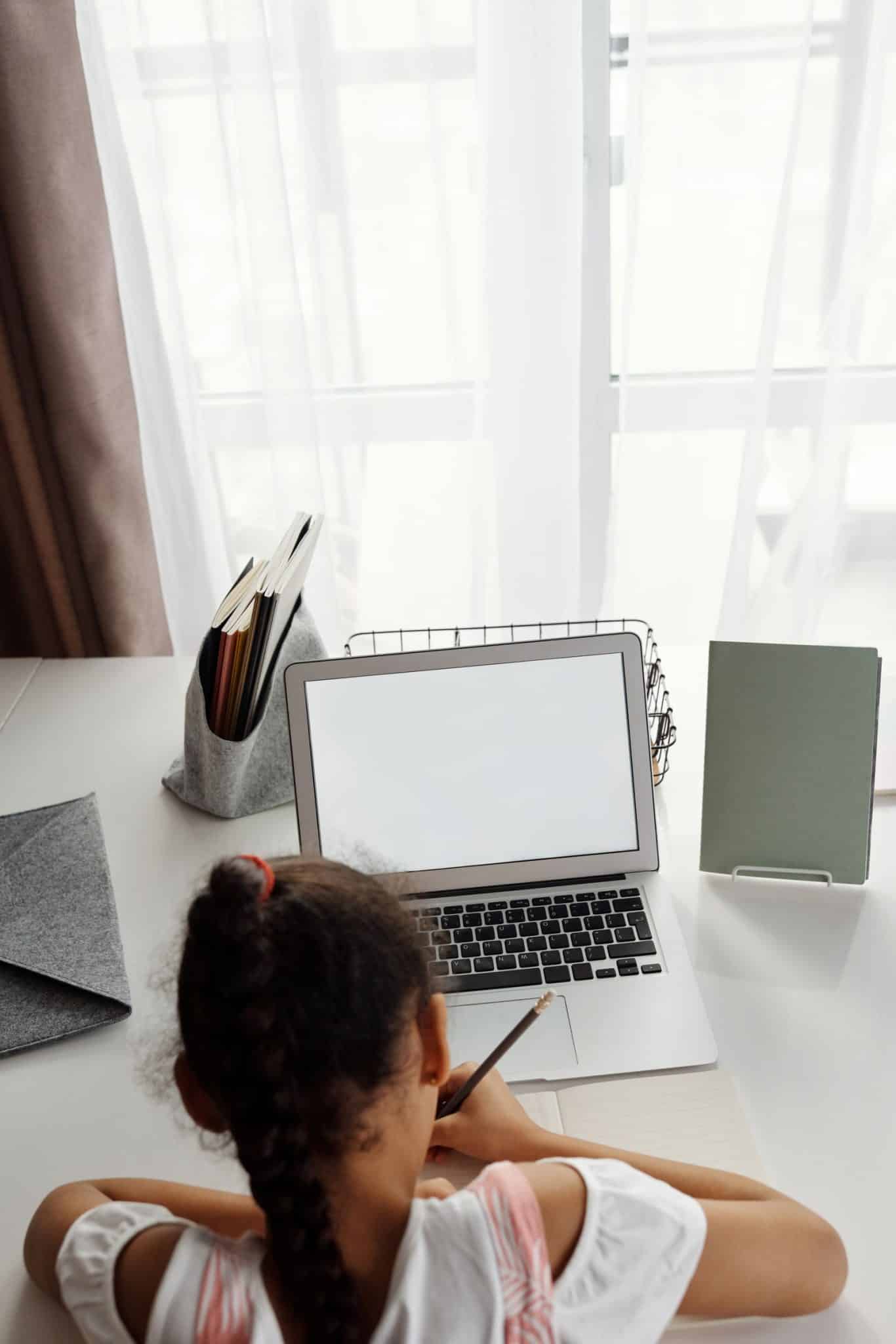 A student studying on a laptop at home, representing online AI learning