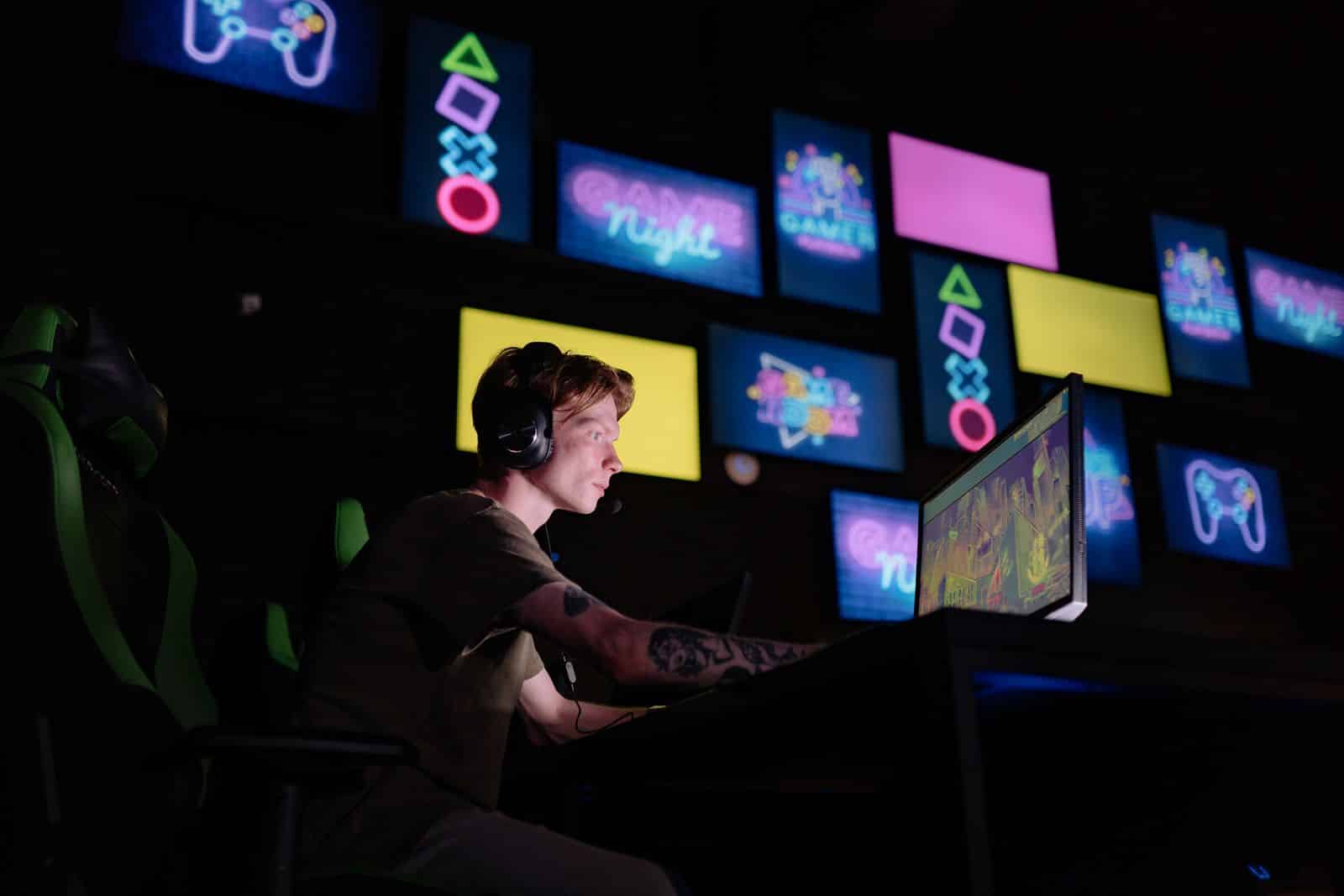 A person playing an immersive space-themed video game on multiple screens