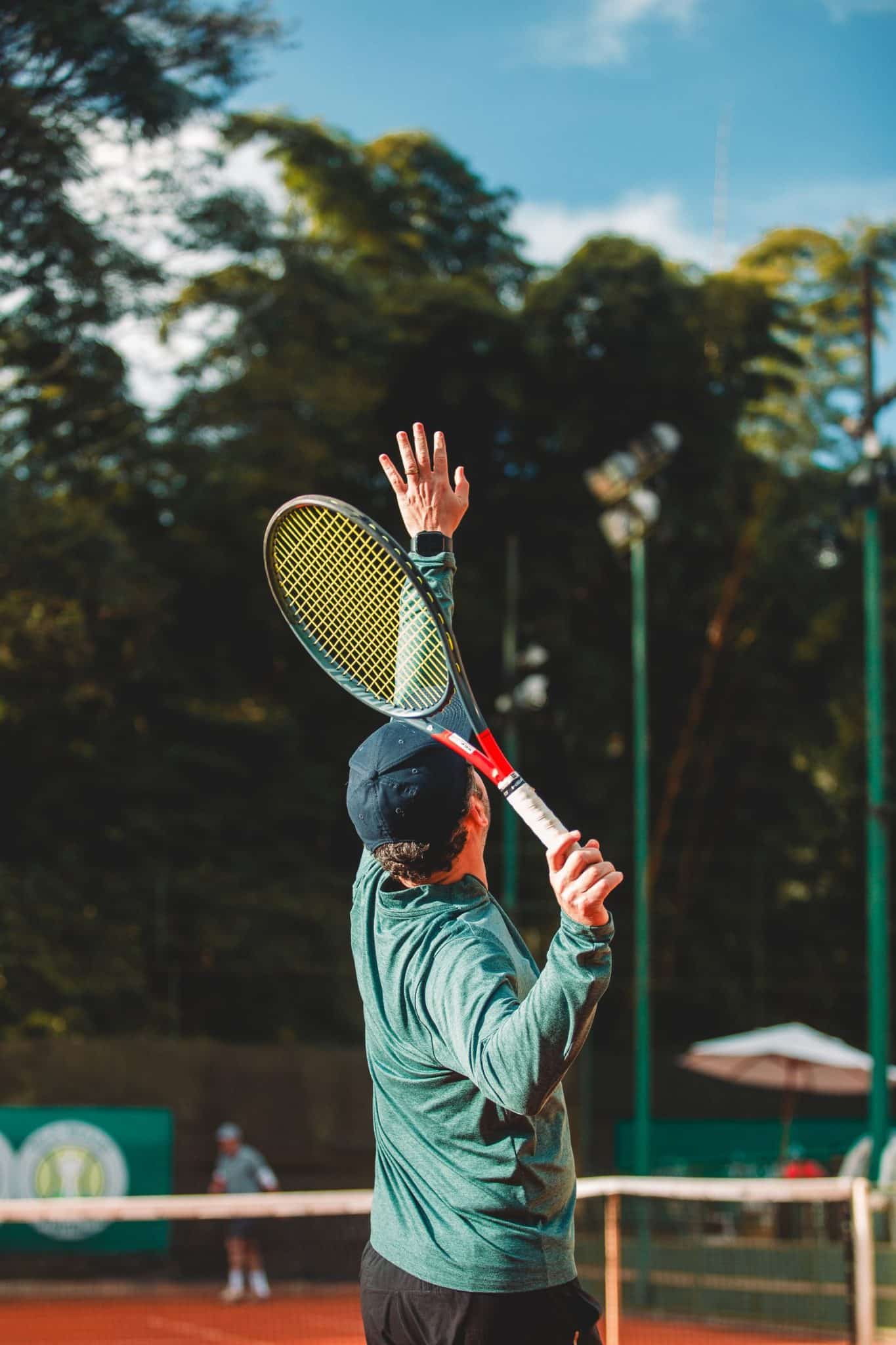 A tennis player captured mid-serve on an outdoor court