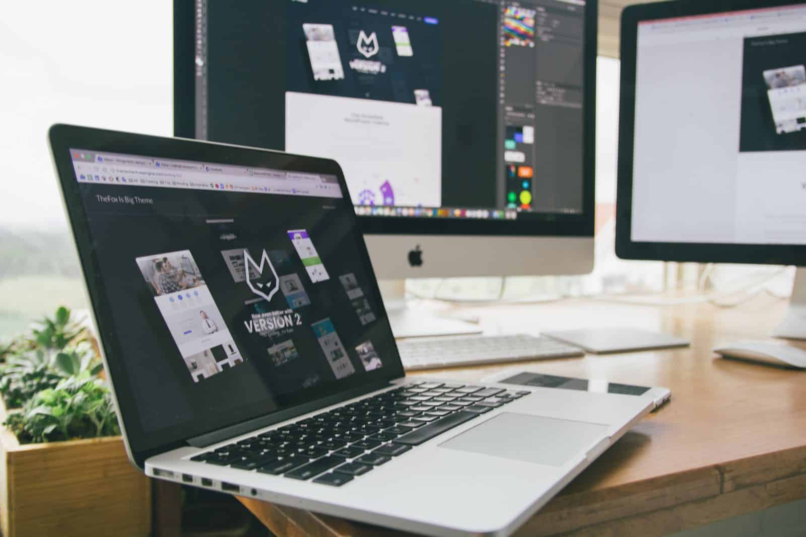 Modern computer and notepads on a desk, representing 10Web AI website builder