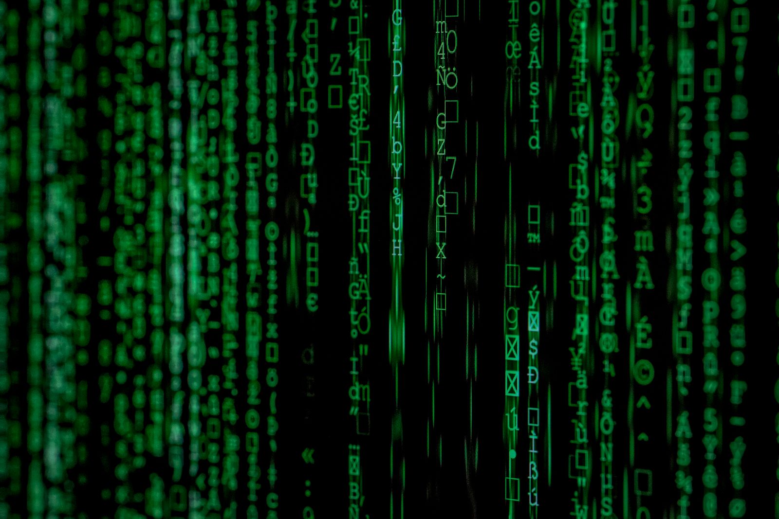 Green matrix-style binary code on screen representing Anthropic's threat intelligence report on AI misuse