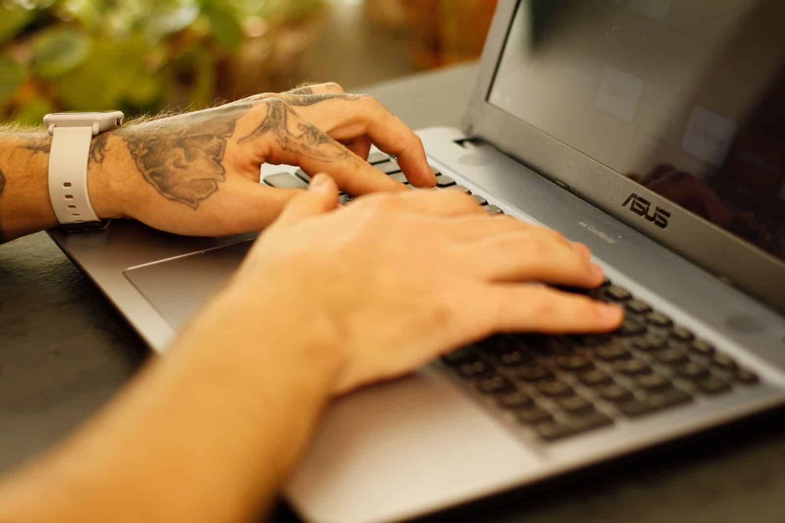 Close-up of a person typing on a laptop, representing Claude in Chrome task execution