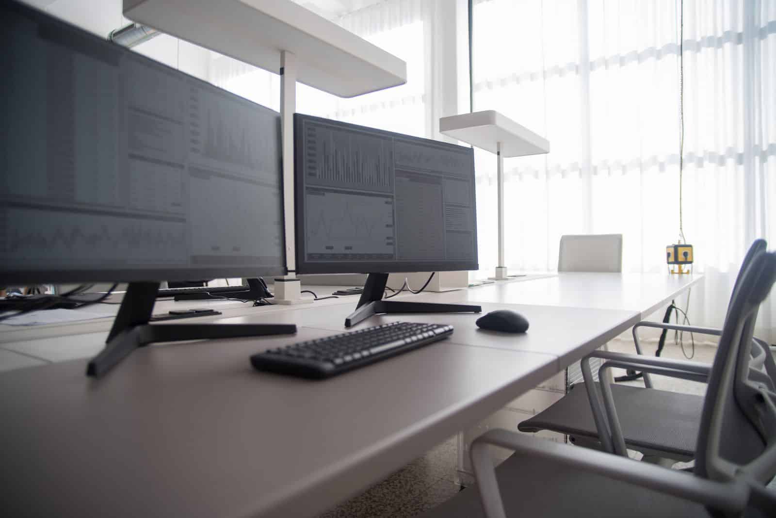 Desk workspace with two monitors, representing Genspark hands-free automation