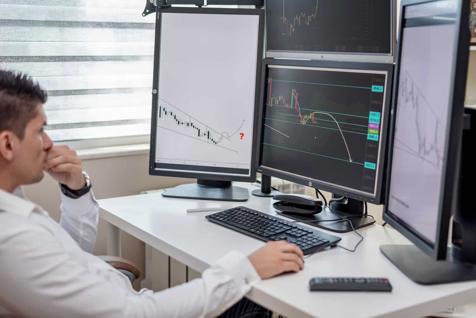Person using a computer with multiple displays, representing Opera Neon action-oriented workflows
