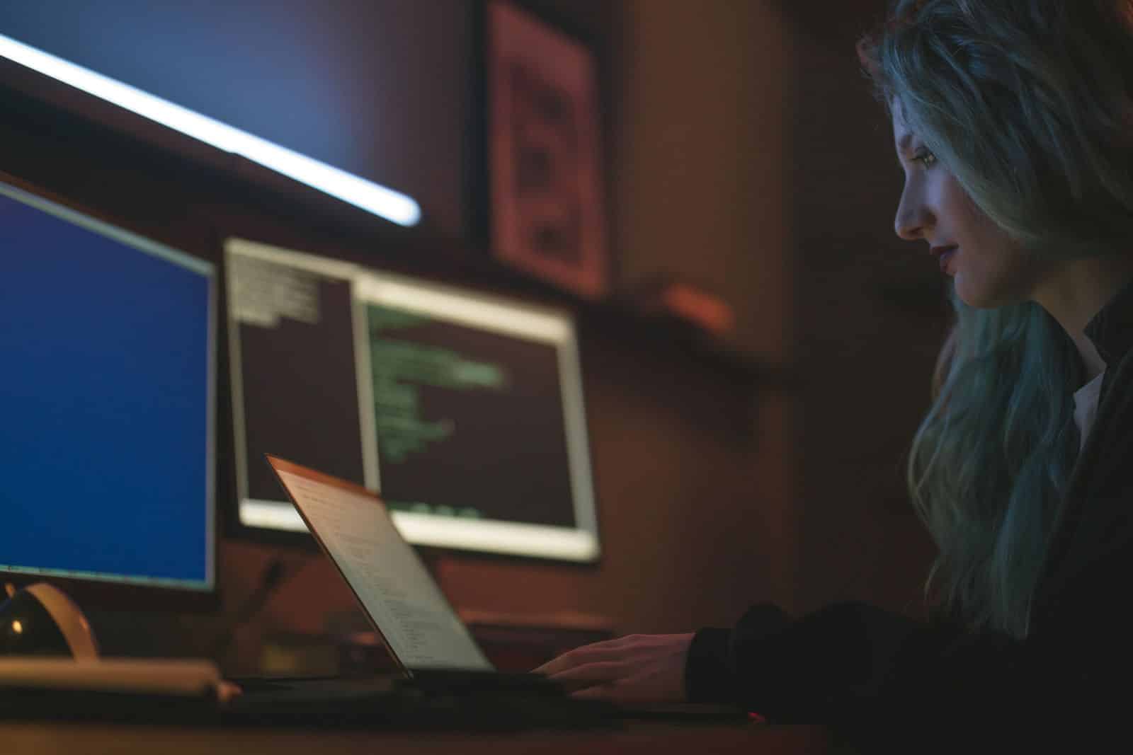 Researcher working across multiple monitors, representing Perplexity Comet deep research
