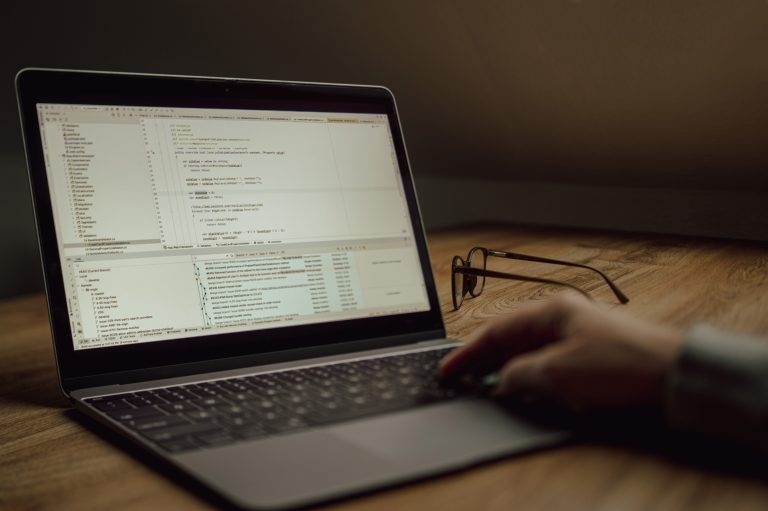Developer debugging code on a laptop after WordPress buttons vanished on production
