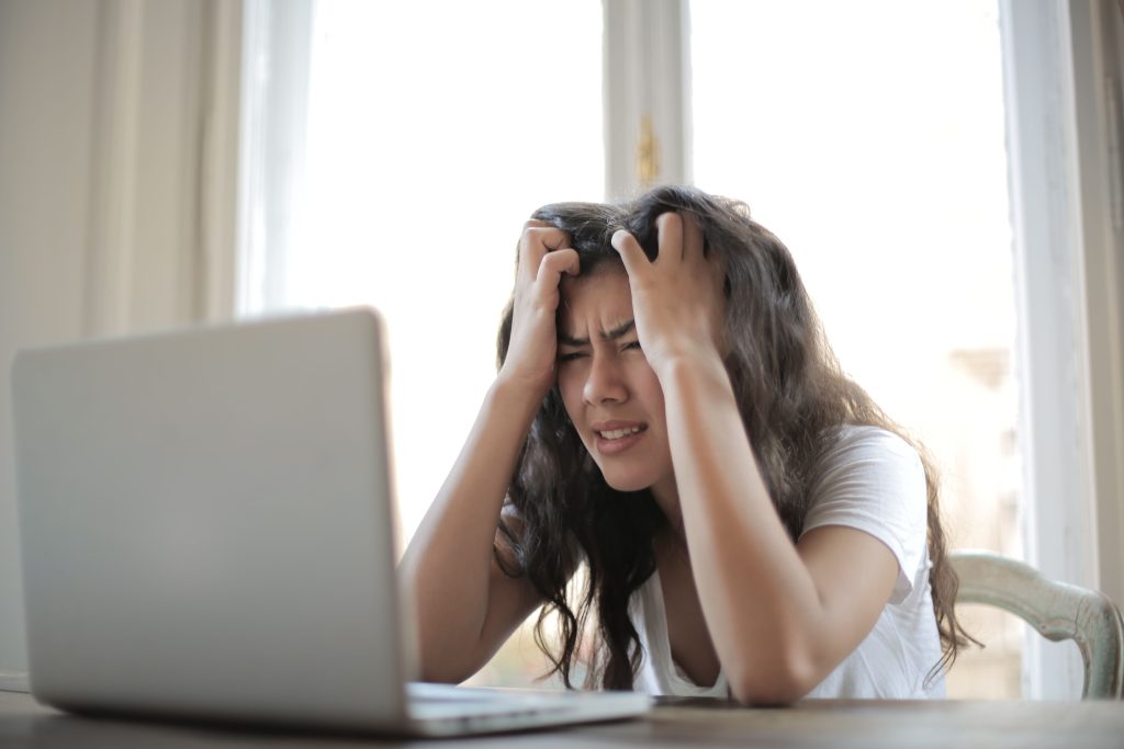 frustrated person staring at a laptop screen during a chatgpt outage